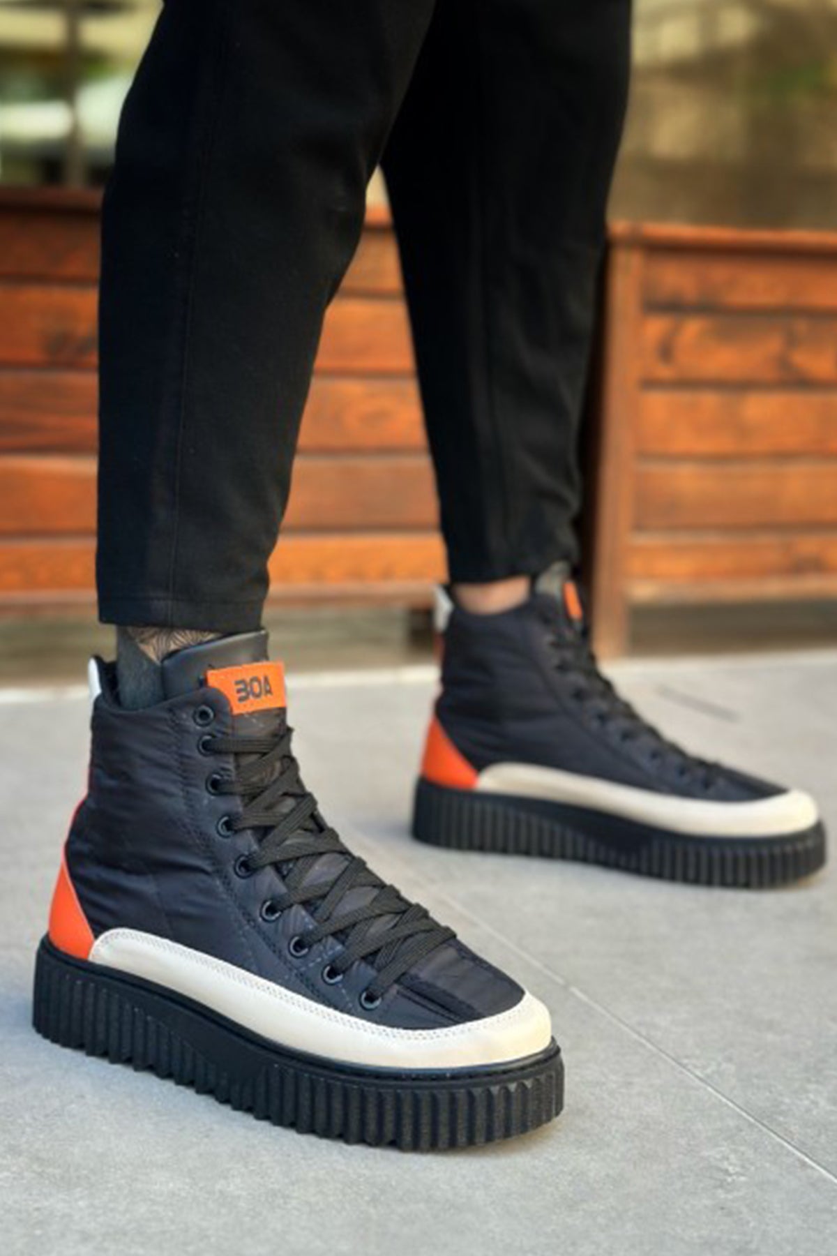 Men's lace-up boots with orange heel tab, dark navy upper, white toe cap, thick tread sole
