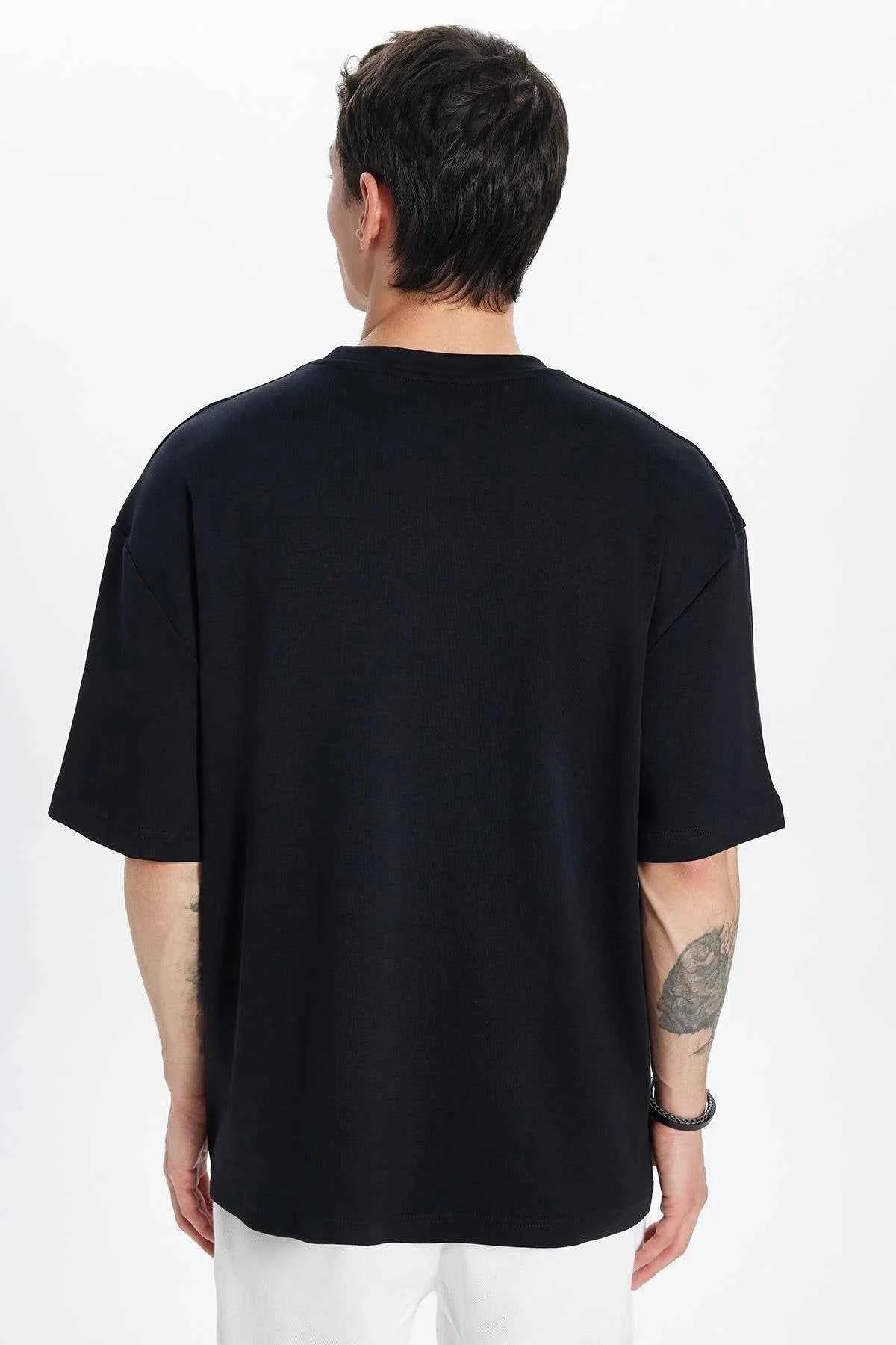 Men's oversize black crew-neck T-shirt, back view with short sleeves