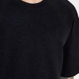 Black crew-neck T-shirt neckline detail with short sleeves