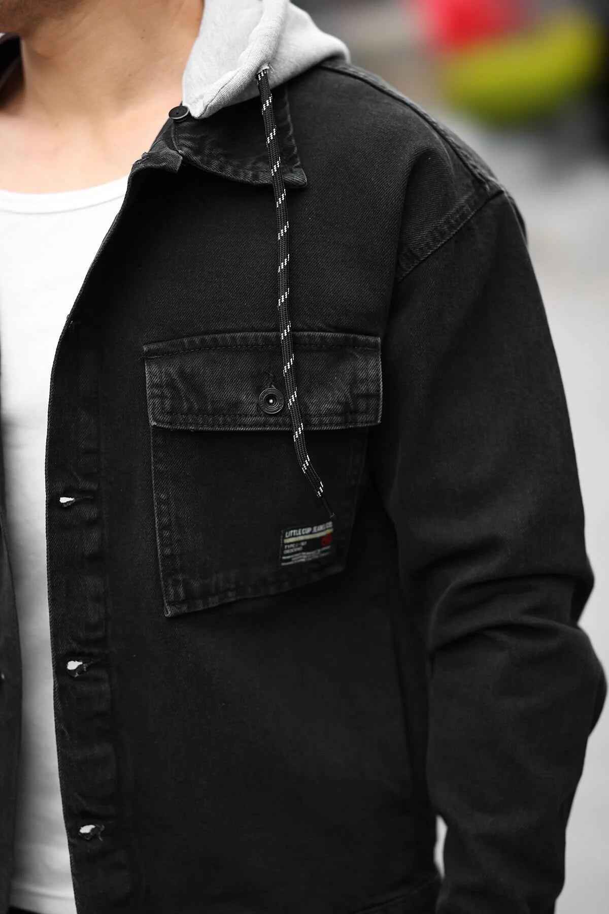 Black denim jacket with chest pocket and stitched detailing, sherpa-lined collar
