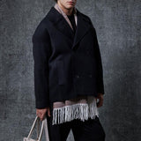 Men's oversized black double-breasted coat, 3/4 view, structured lapels and buttons.