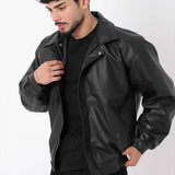 Oversized black leather jacket with snap front and stand collar