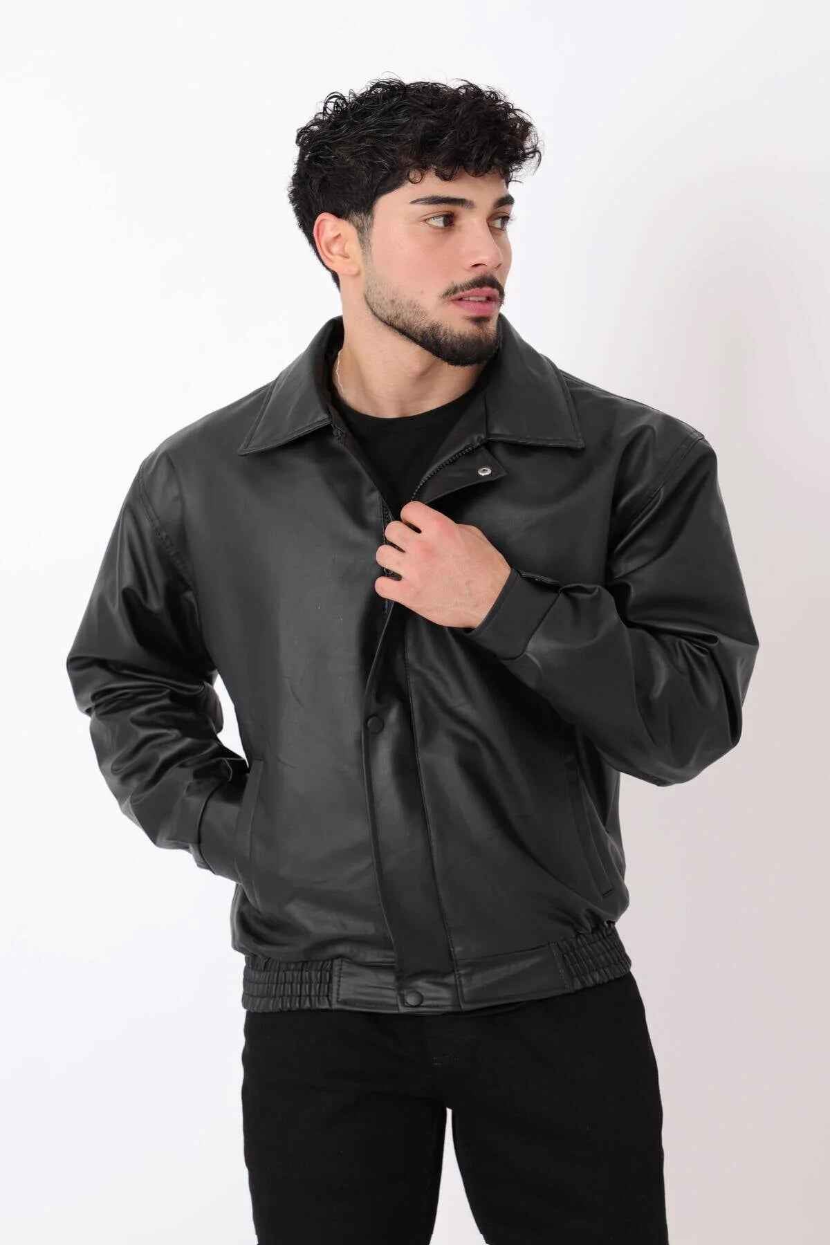 Oversized black leather jacket with stand collar, ribbed hem, and snap cuffs
