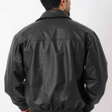 Oversized black leather jacket, back view with stitched yoke and ribbed hem