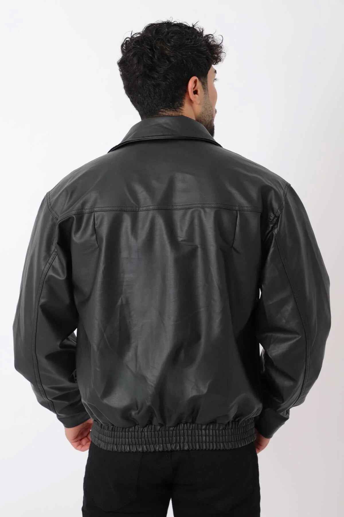 Oversized black leather jacket, back view with stitched yoke and ribbed hem