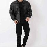 Oversized black leather jacket with stand collar and snap placket, full-body