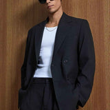 Black oversized suit blazer with notched lapels and trousers, front side view