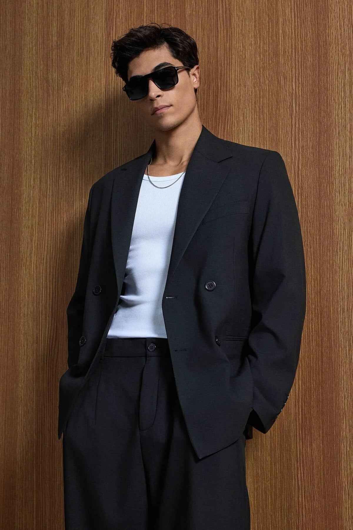 Black oversized suit blazer with notched lapels and trousers, front side view