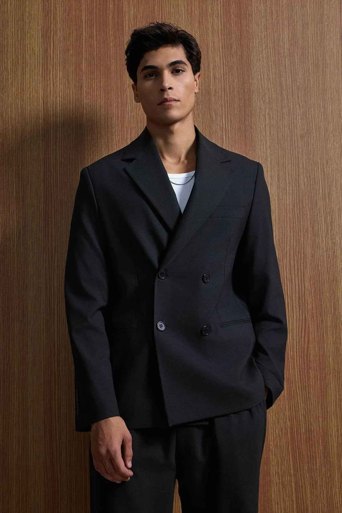 Black double-breasted style suit blazer and matching trousers, front close-up