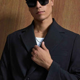 Black oversized suit blazer close-up, lapels and buttons with sunglasses