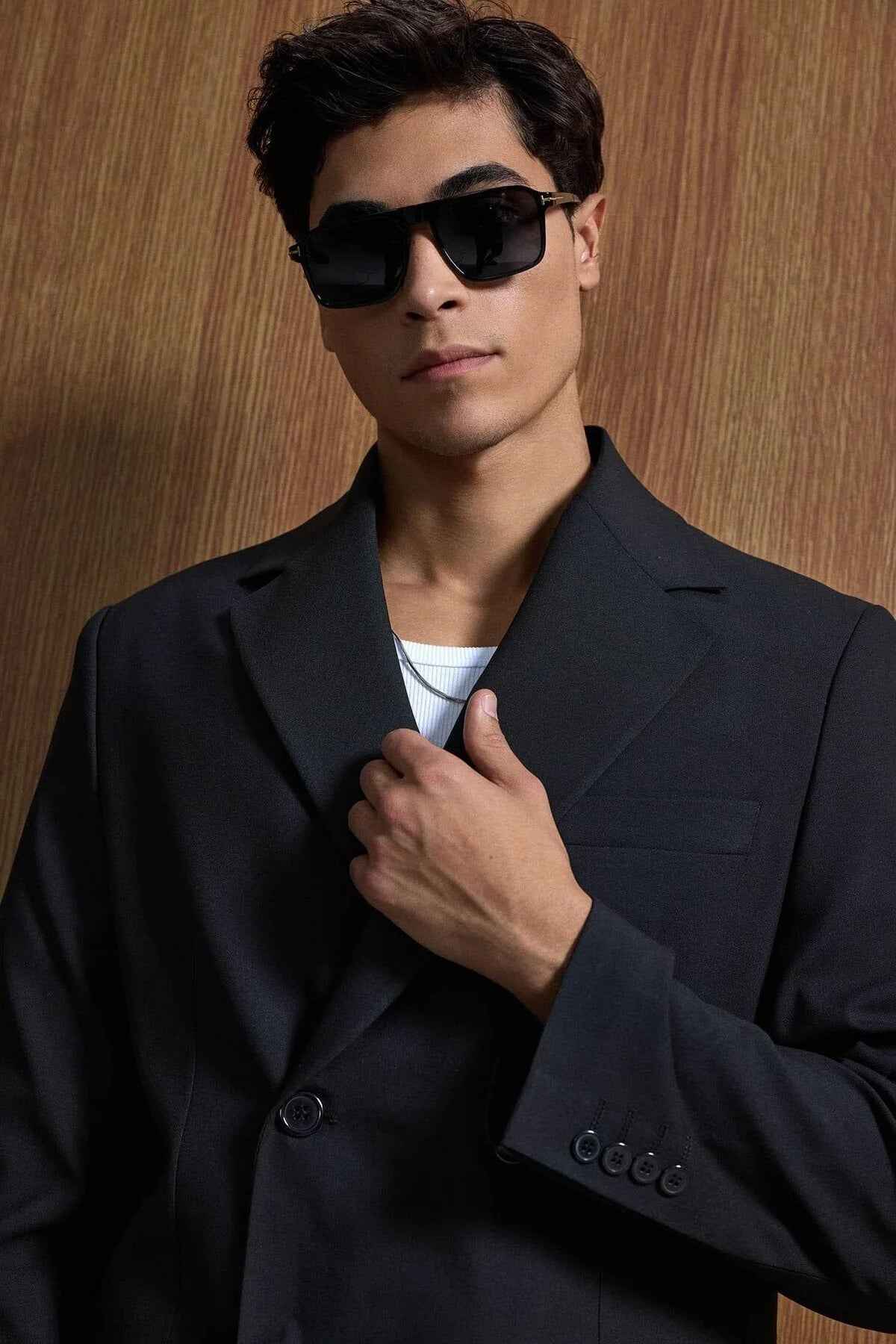 Black oversized suit blazer close-up, lapels and buttons with sunglasses