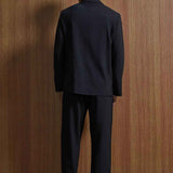 Black oversized suit jacket and trousers, back view