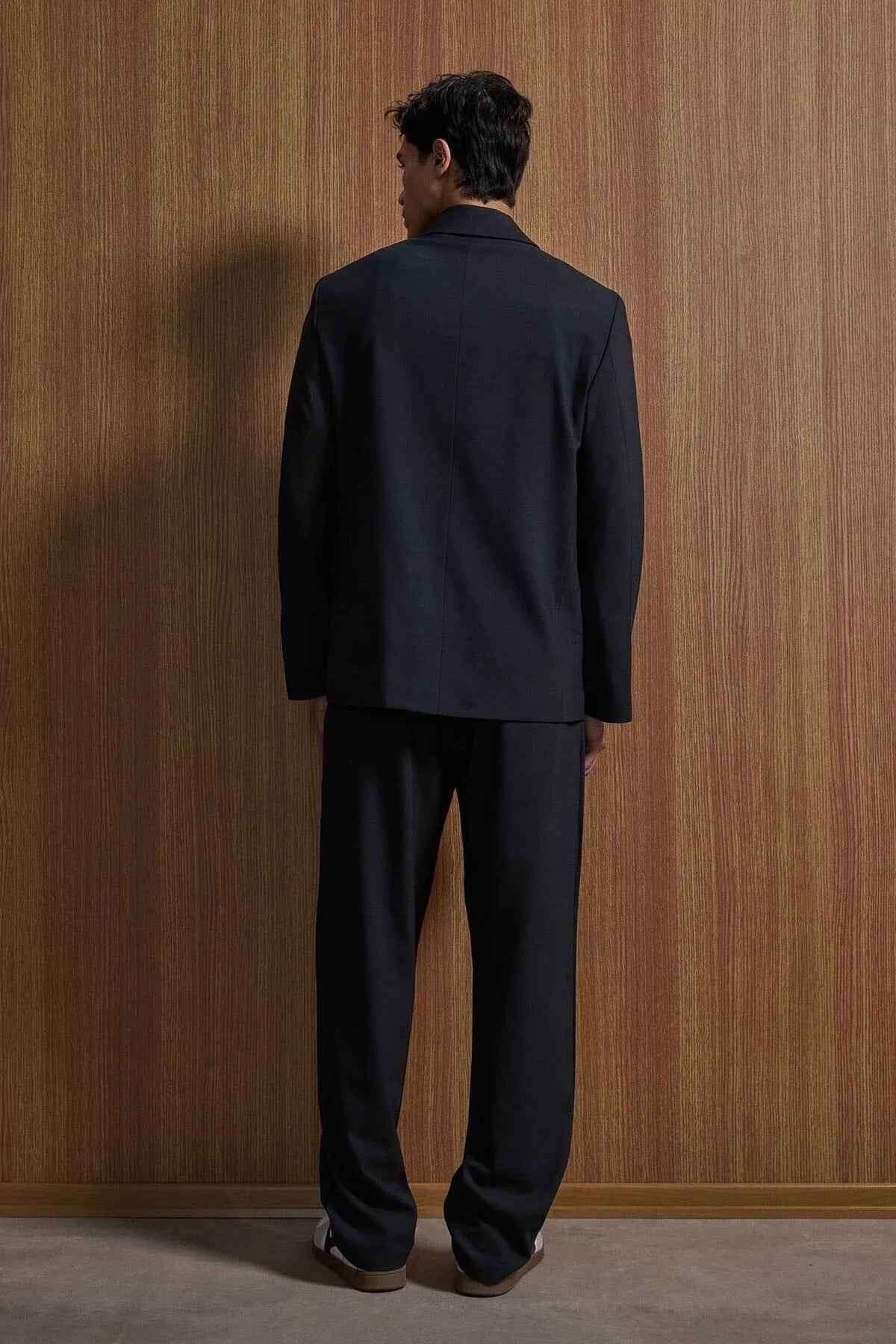 Black oversized suit jacket and trousers, back view