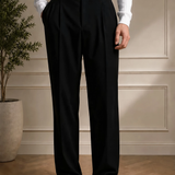 Men's black dress pants front view with pleats and black belt