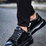 Men's black patent leather sneakers, angled side view with shiny toe cap