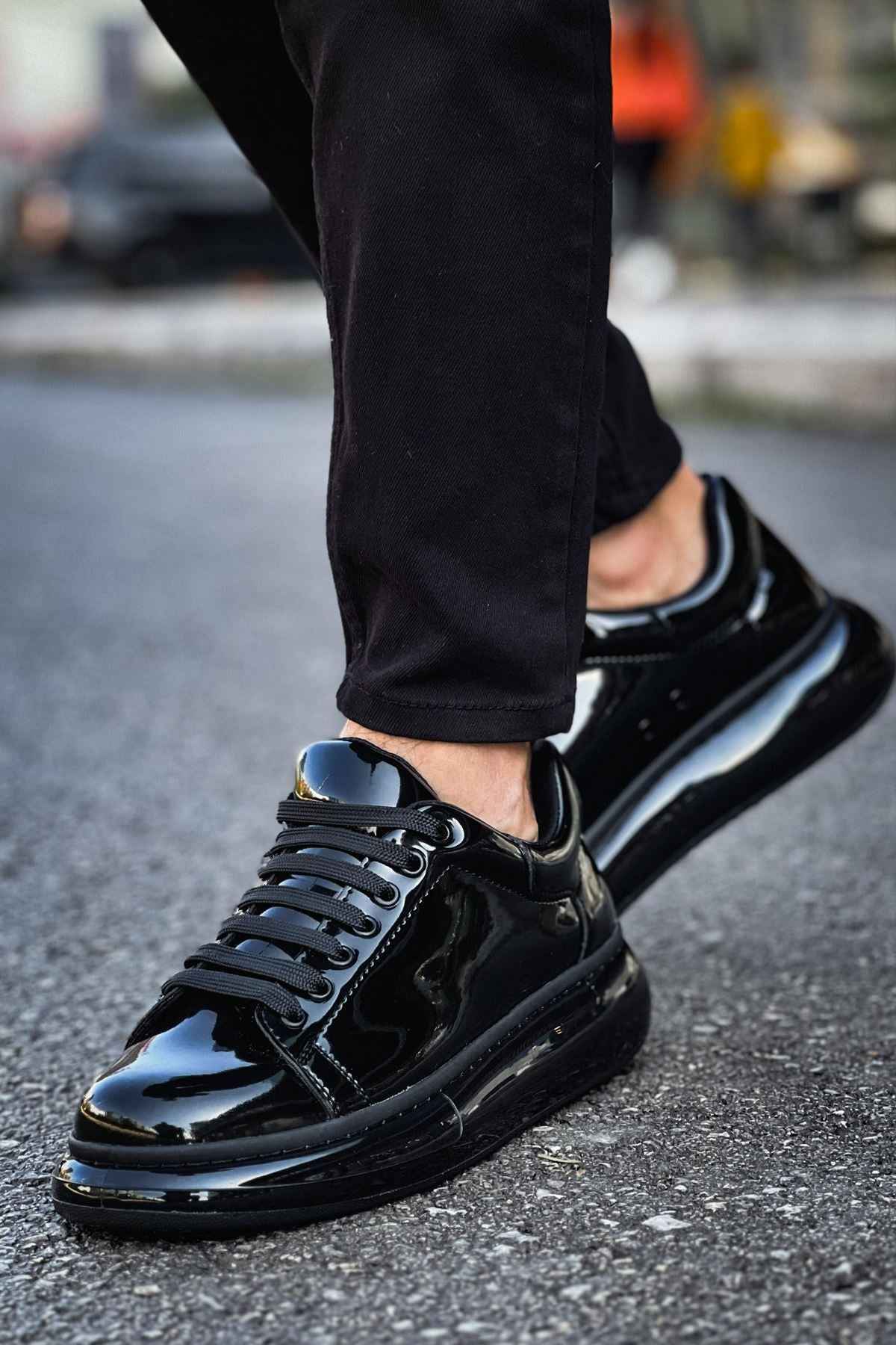 Men's black patent leather sneakers, angled side view with shiny toe cap