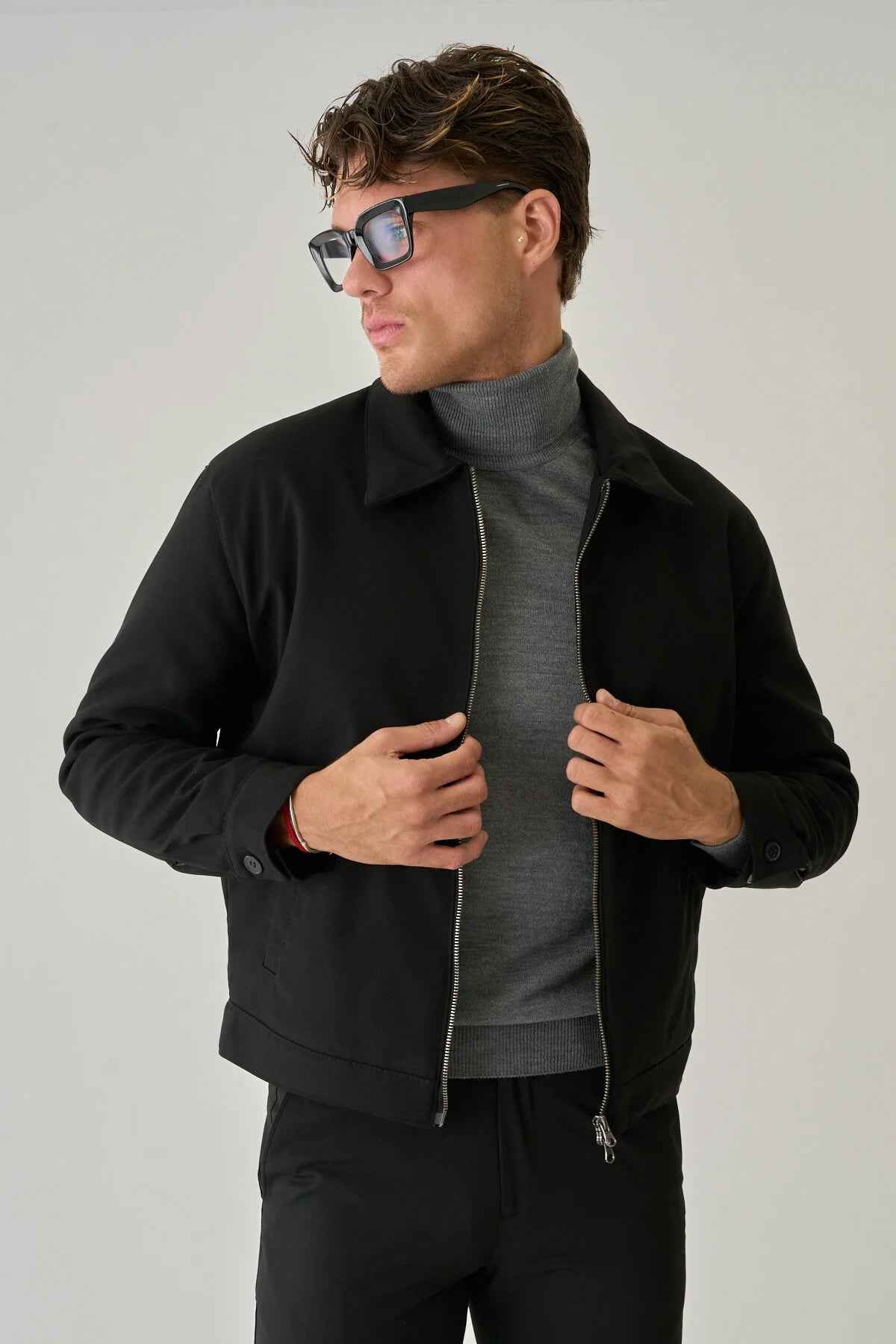Men's black jacket with zip front, stand collar, and two side pockets