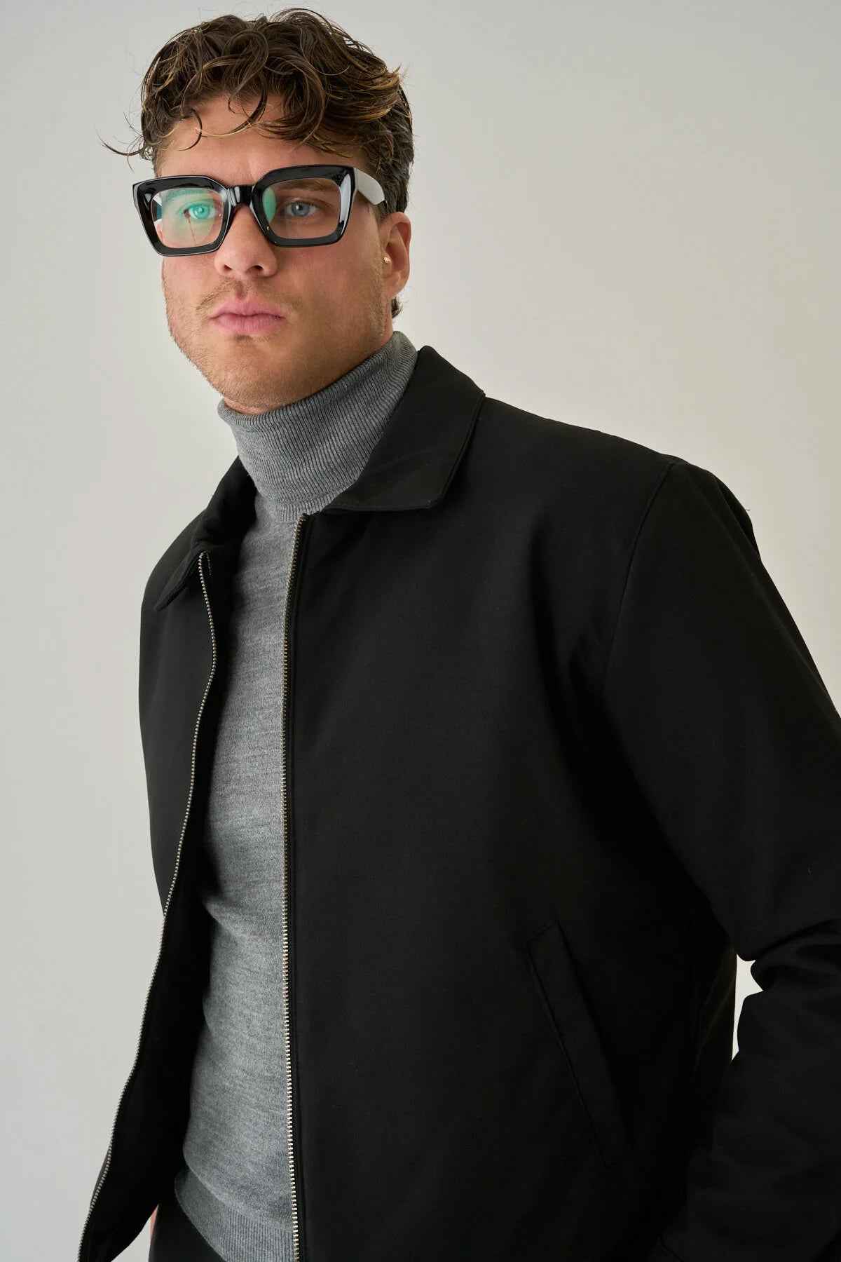 Men's black jacket close-up with stand collar and zip front