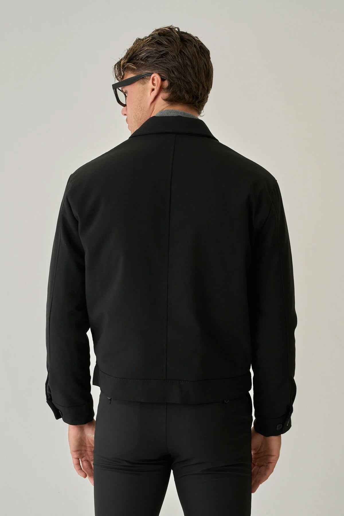 Men's black jacket back view with zip-up yoke and full sleeves