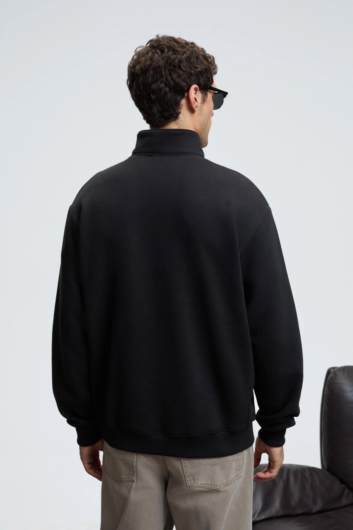 Black back view zip stand-collar sweatshirt with ribbed cuffs