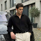 Men's black long-sleeve button-up shirt with open collar and chest placket