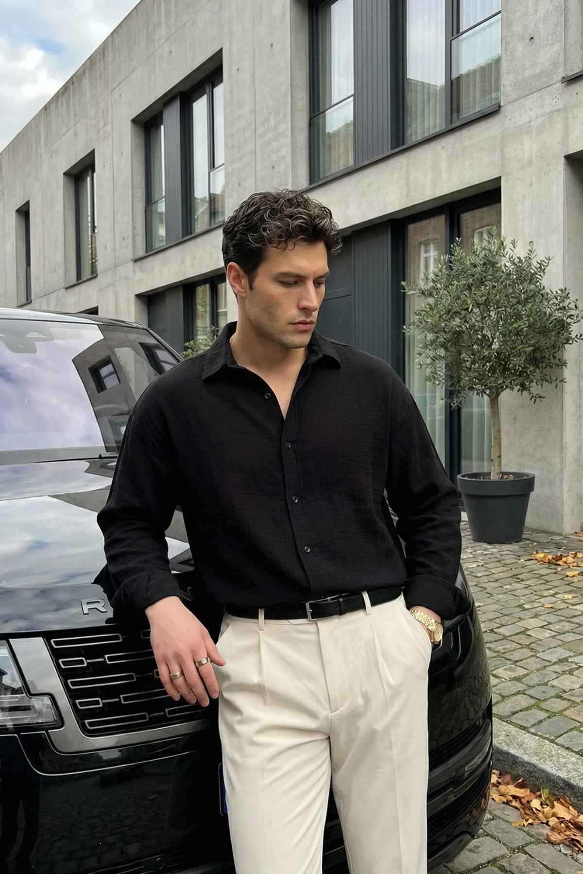 Men's black long-sleeve button-up shirt with open collar and chest placket