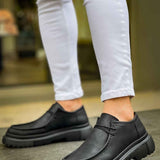 Men's black lace-up shoes with thick tread sole, side view