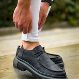 Men's black lace-up shoes with thick tread sole, front 3/4 view