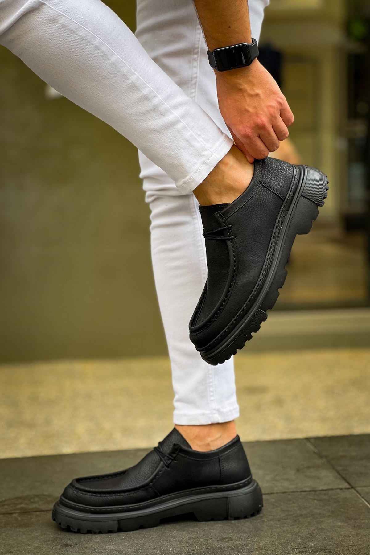Men's black lace-up shoes with thick tread sole, heel and side detail