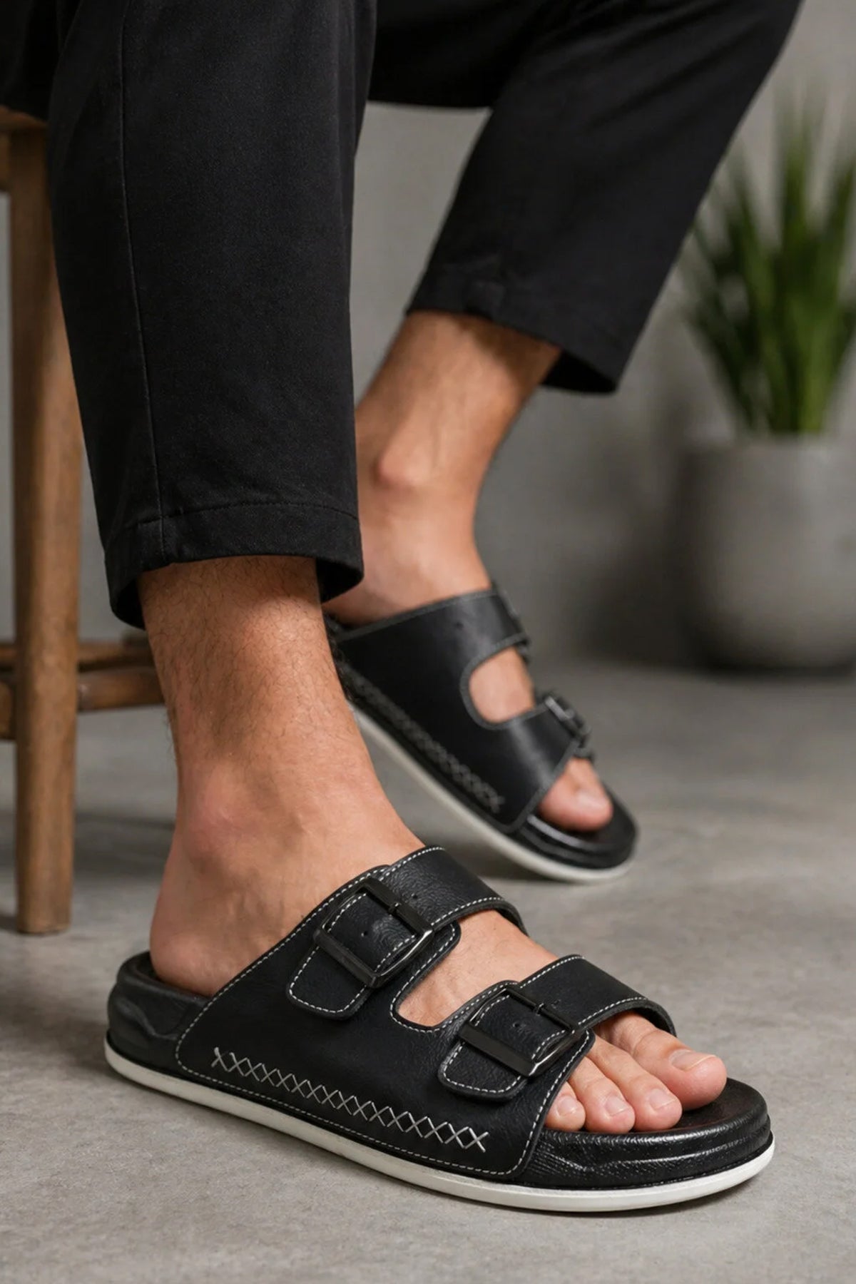 Men's black slide slippers with two wide straps and stitched trim