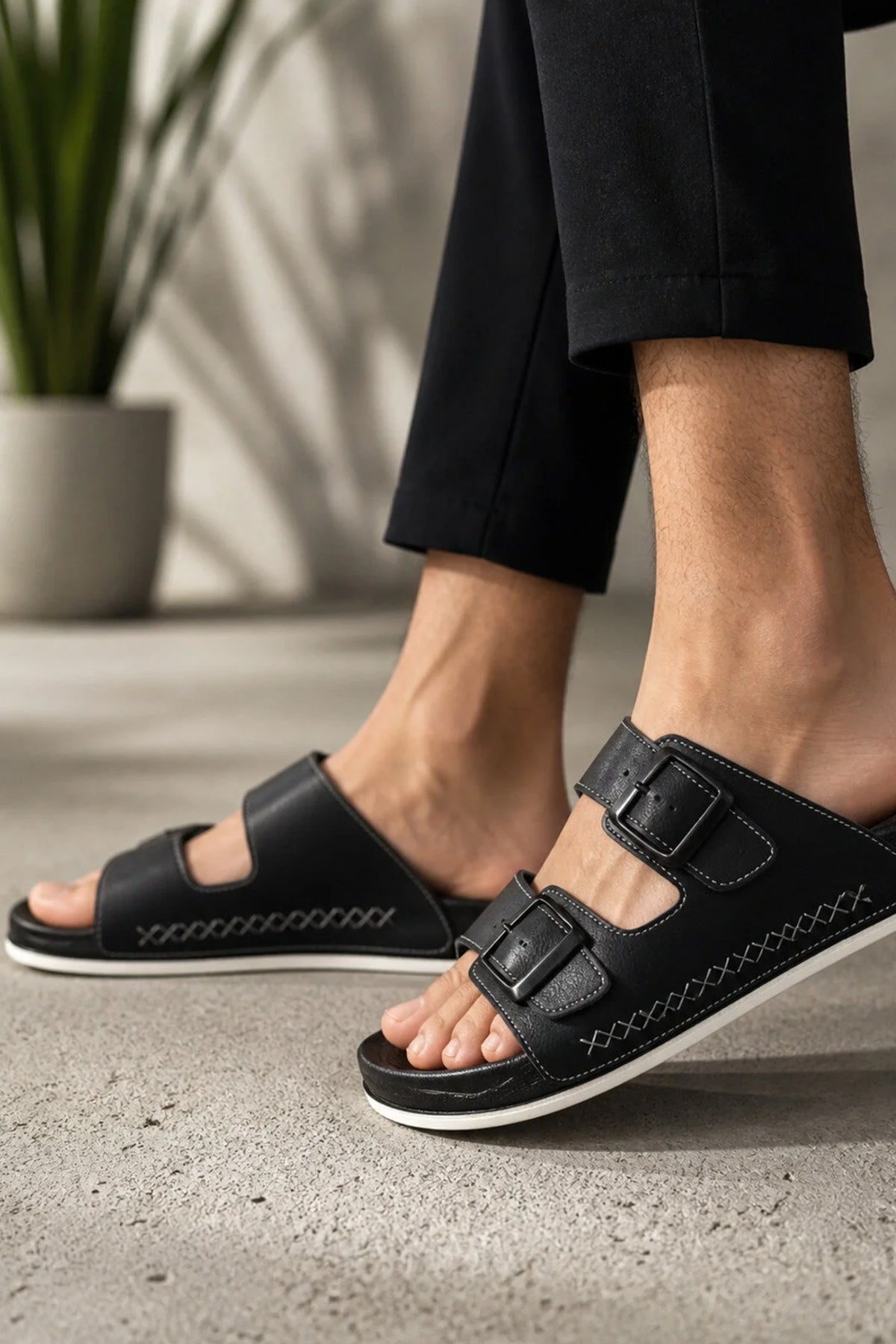 Men's black slide slippers with double straps and stitched side detailing