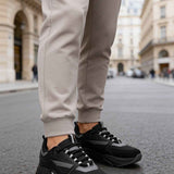 Men's black lace-up sneakers with dark gray stripes and chunky rubber sole