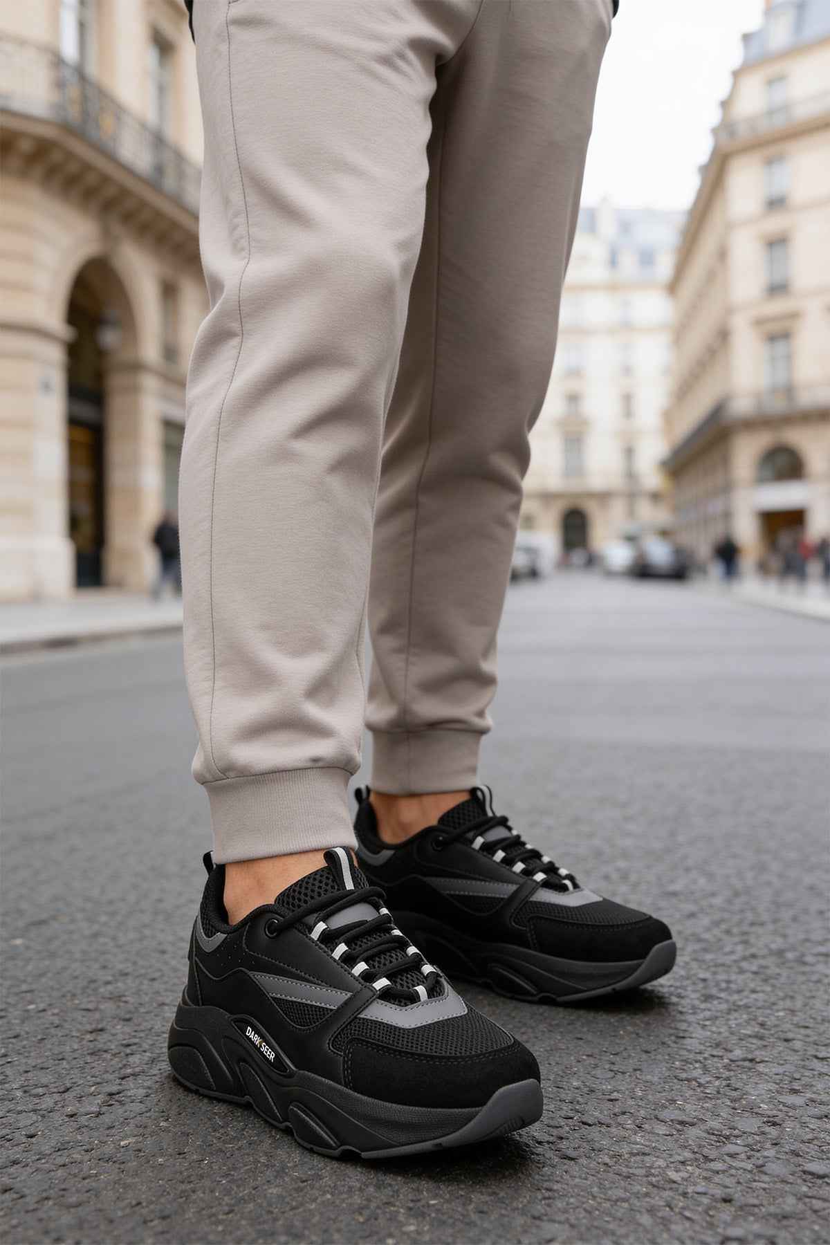 Men's black lace-up sneakers with dark gray stripes and chunky rubber sole
