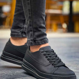 Men's black low-top sneakers, lace-up with rubber sole and textured side panels