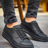 Men's black low-top sneakers with lace-up closure and dark rubber midsole