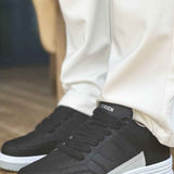 Men's black sneakers with lace-up front and white midsole
