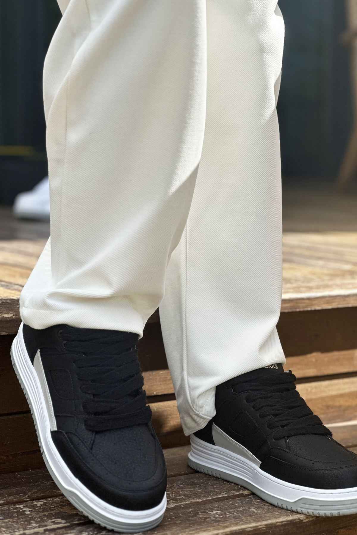 Men's black low-top sneakers with white side stripe and thick white sole