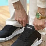 Men's black sneakers with lace-up closure and white platform sole