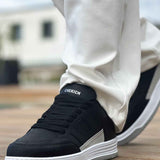 Men's black sneakers with stitched side panel and white rubber sole