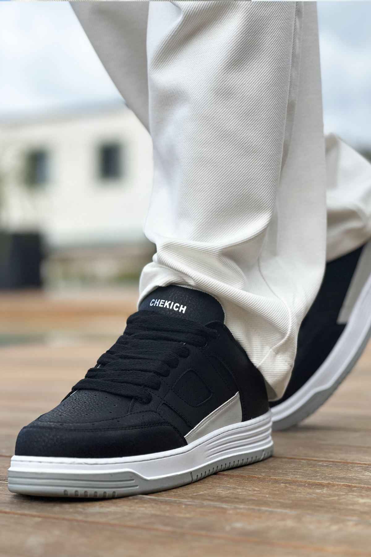 Men's black sneakers with stitched side panel and white rubber sole