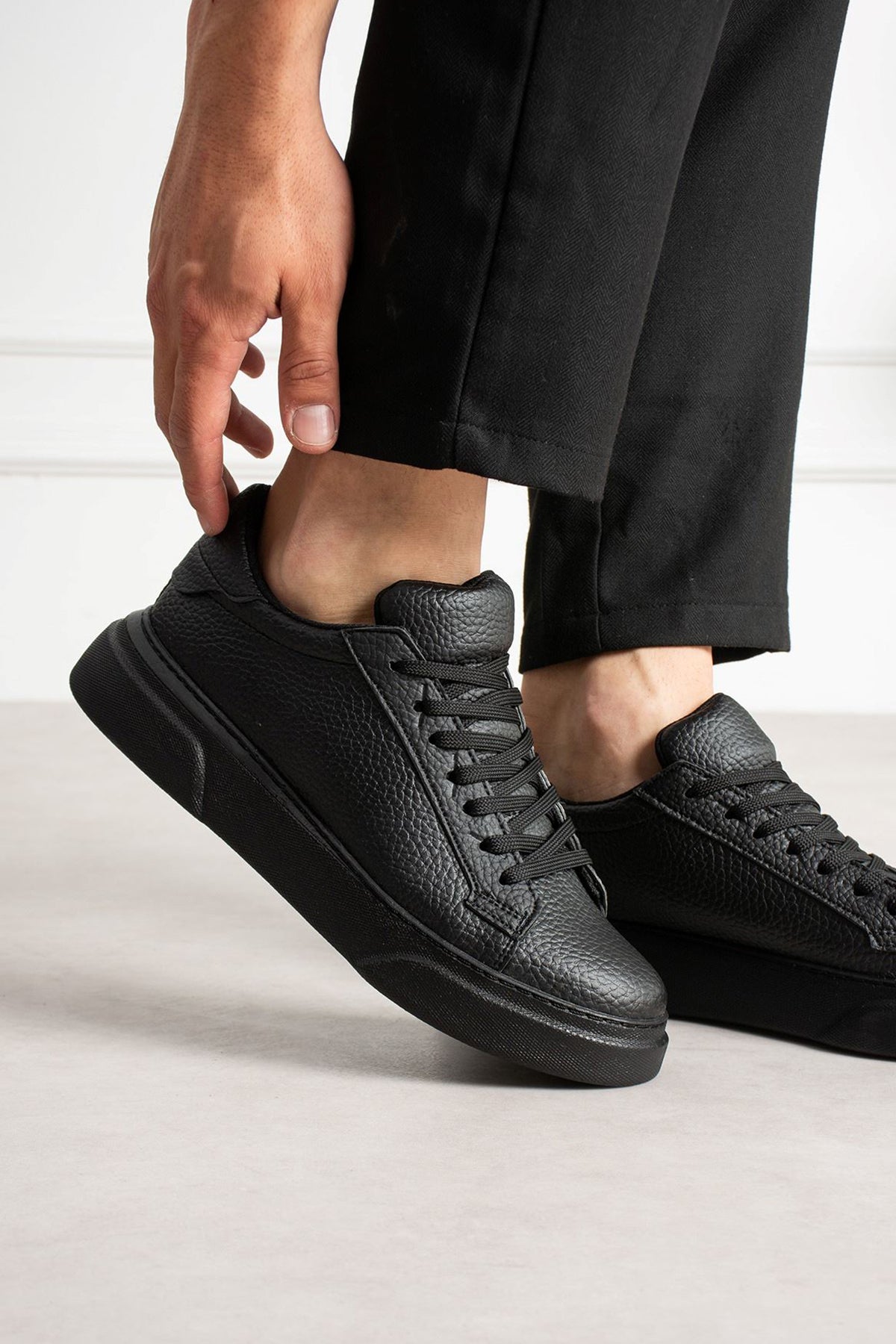 Men's black leather sneakers with lace-up front and padded ankle collar