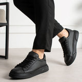 Men's black lace-up sneakers with low profile and thick rubber outsole