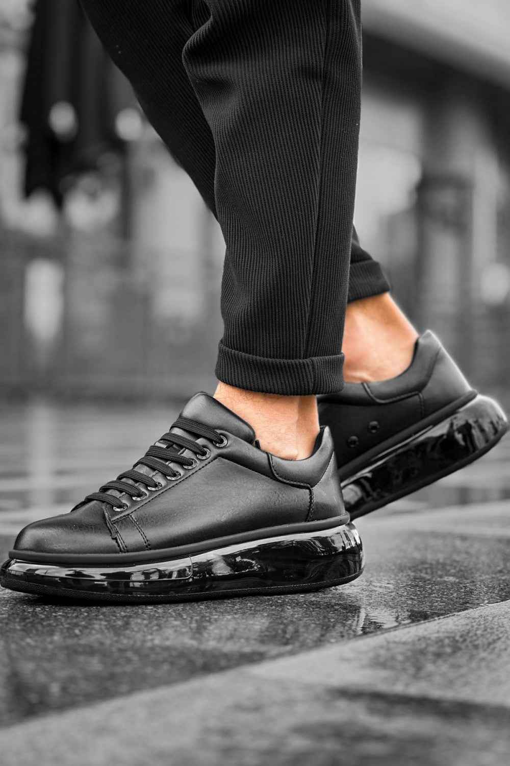 Black low-top sneakers, lace-up front and glossy toe panel