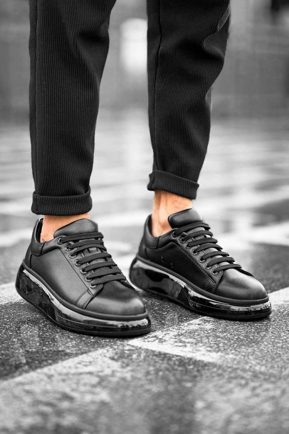 Black lace-up sneakers with chunky sole and padded heel collar