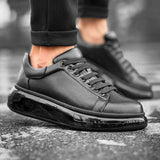 Black lace-up sneakers with textured rubber sole, side logo detail