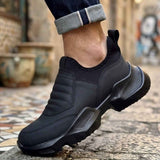 Men's black sneakers with lace-up closure, stitched side panels, and rubber tread sole