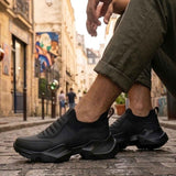 Men's black lace-up sneakers with textured side panels and thick treaded rubber sole