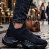 Black lace-up sneakers with knit upper and textured side, chunky rubber sole