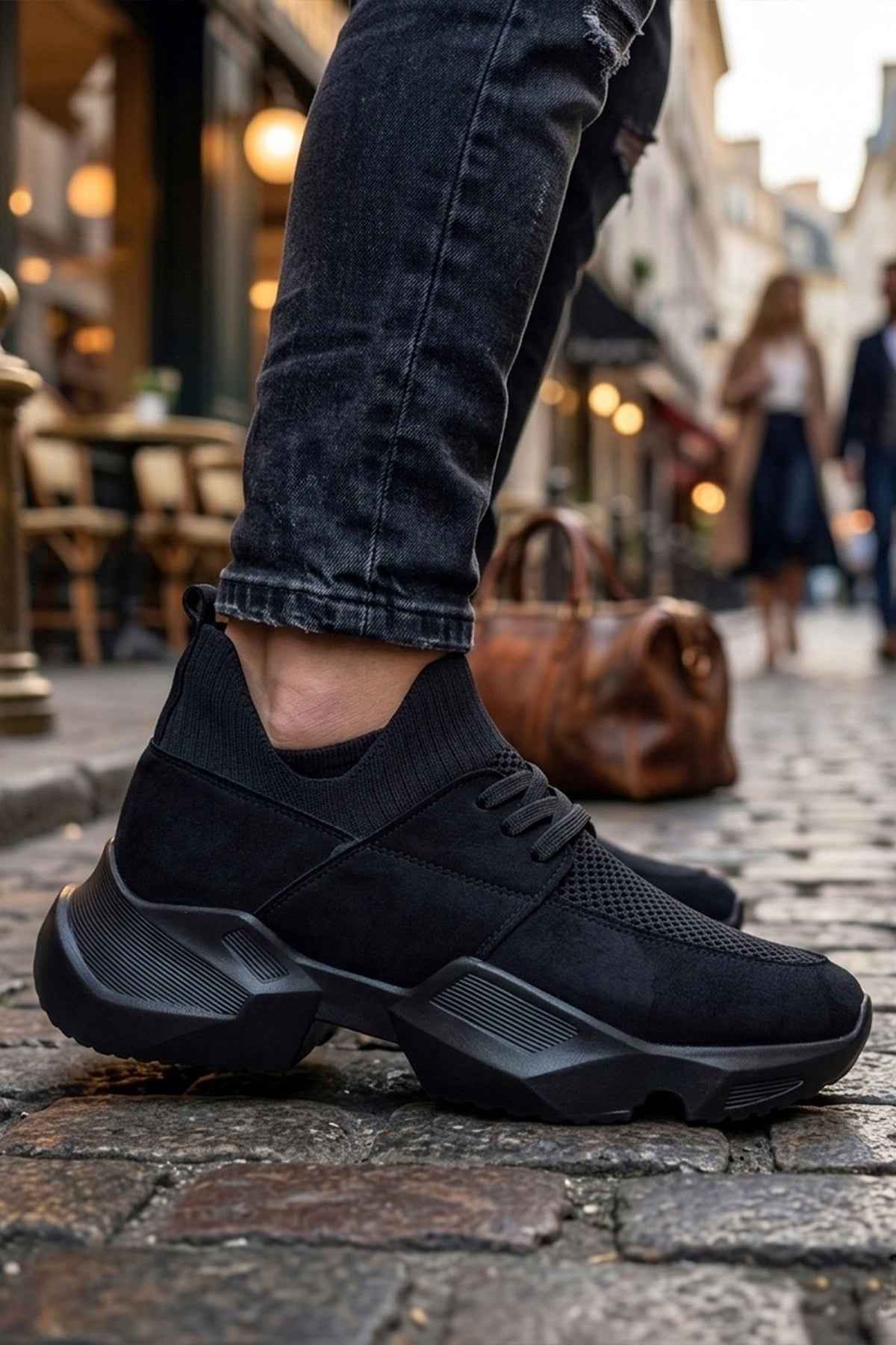 Black lace-up sneakers with knit upper and textured side, chunky rubber sole