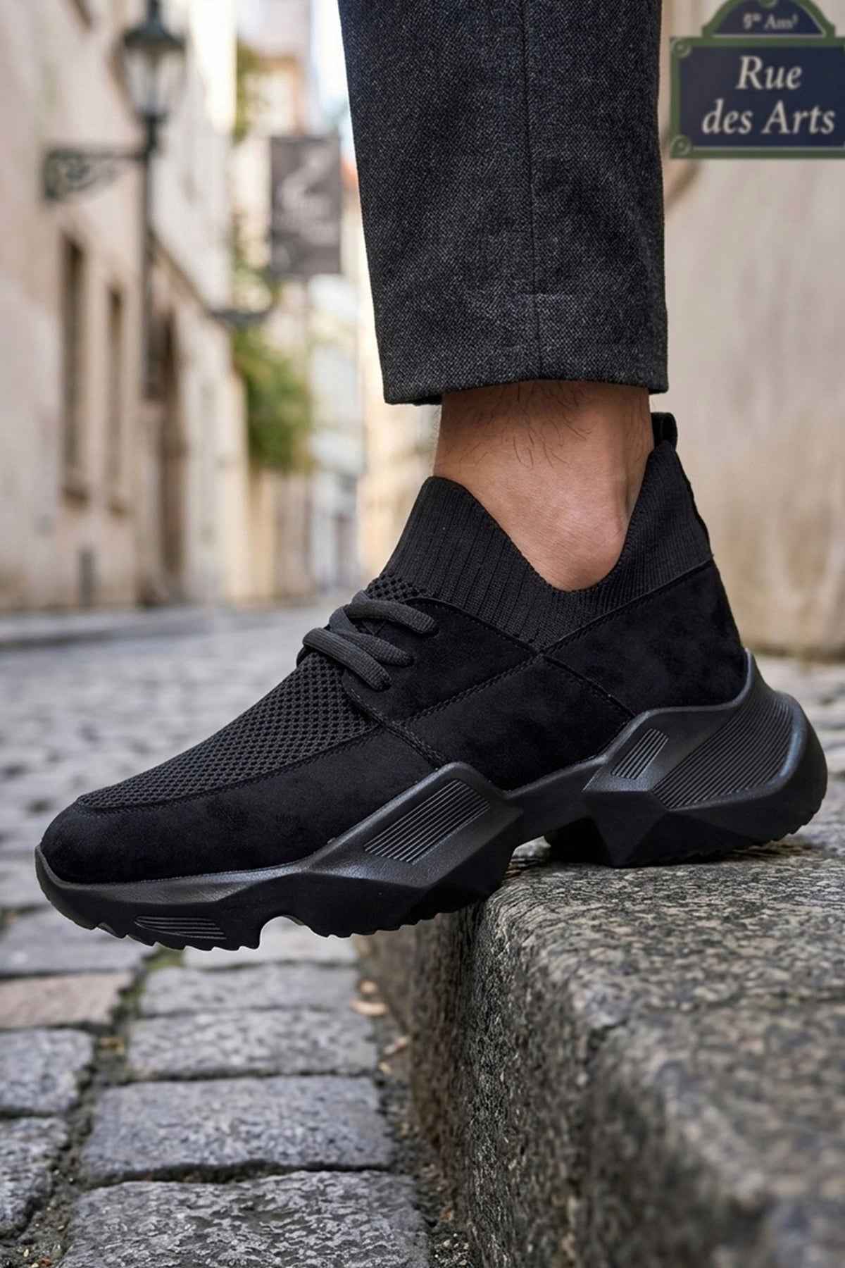 Black knit lace-up sneakers with ribbed sock collar and thick sole